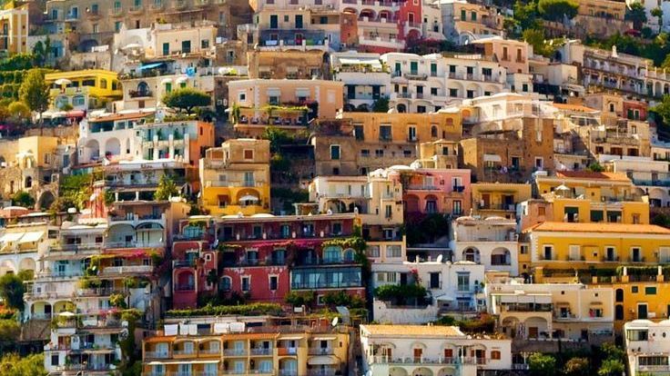 Boat leaving Positano under the Italian flag