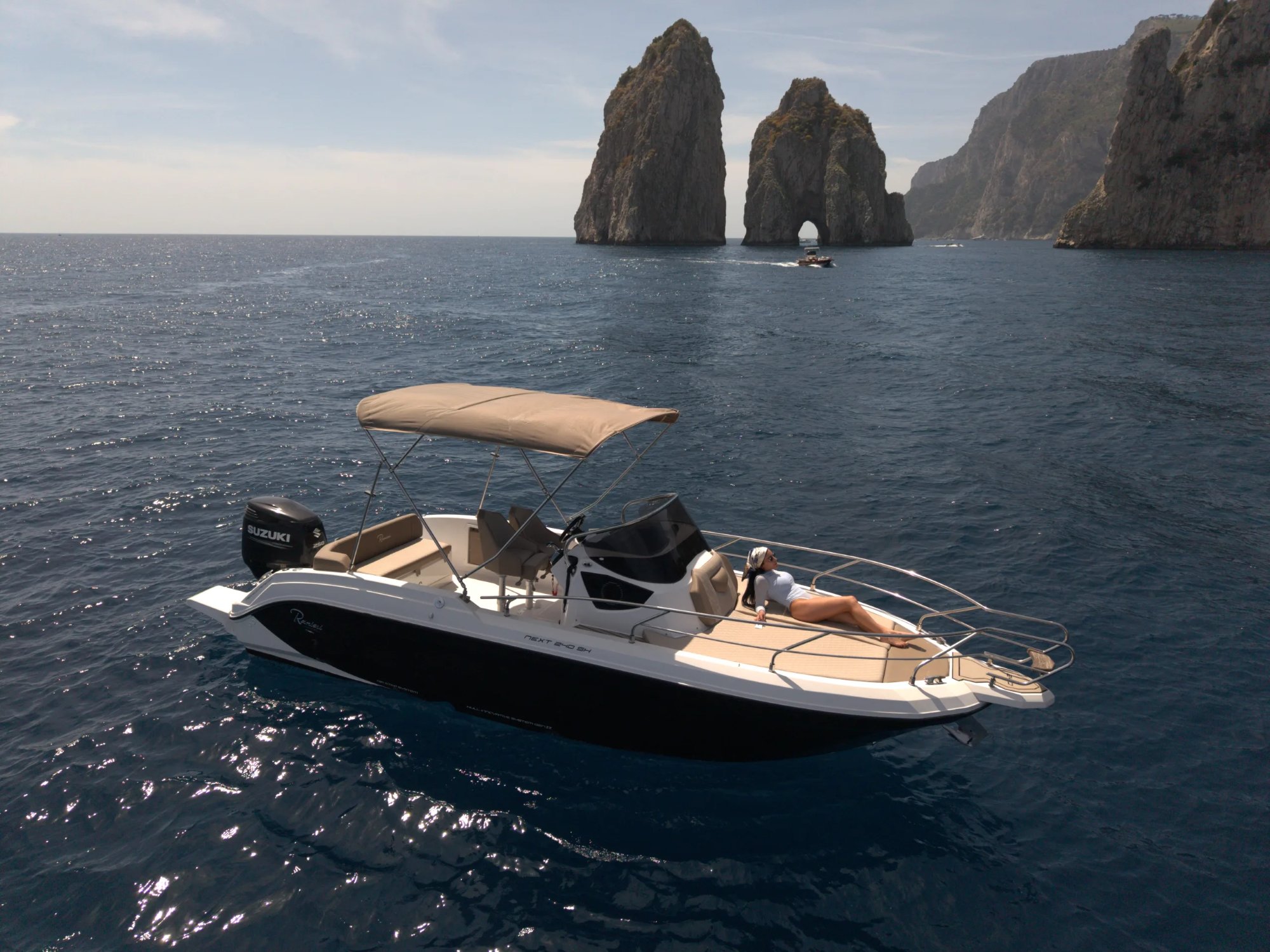 Capri Tour — boat by the Faraglioni of Capri