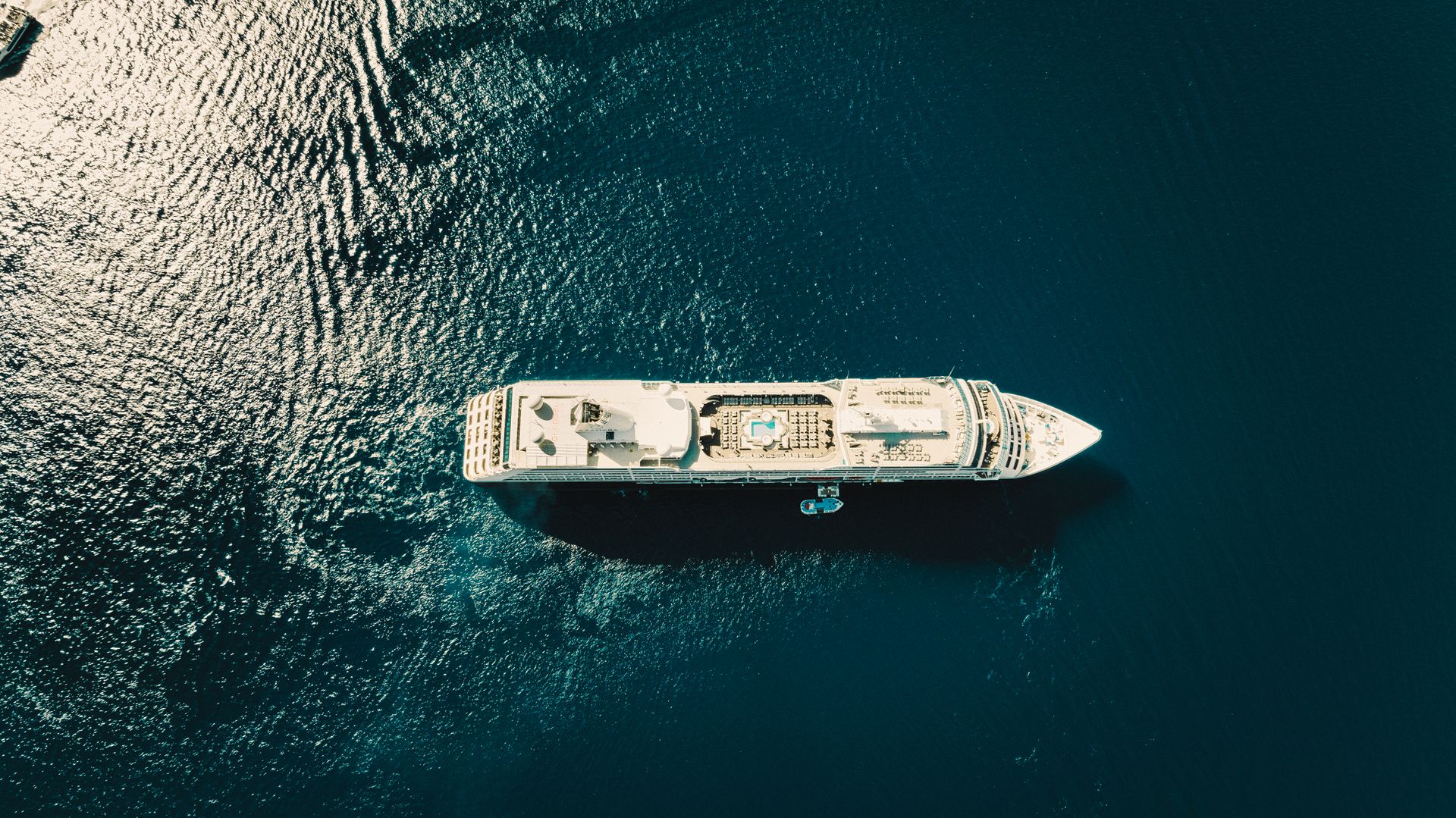 Cruise shore excursions — aerial view of a cruise ship on the blue Mediterranean
