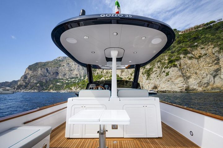The shaded cockpit and teak deck of the Apreamare Gozzo 35