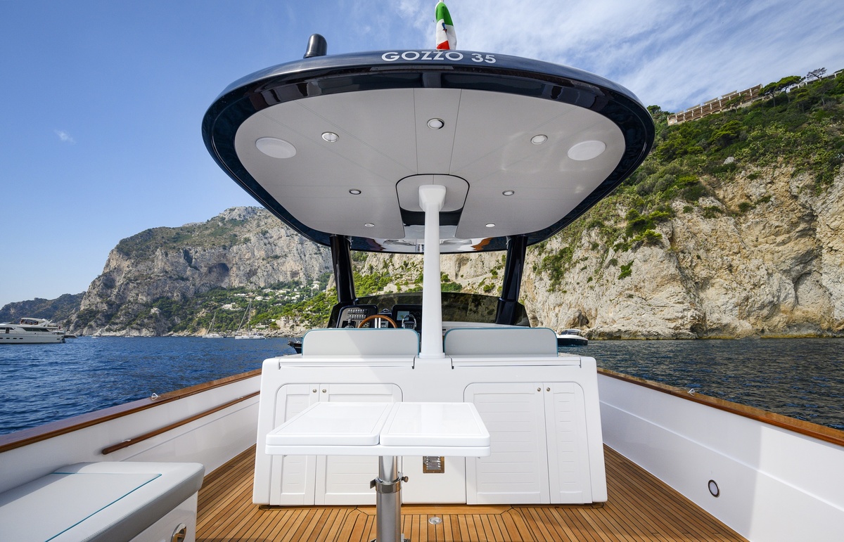 The shaded cockpit and teak deck of the Apreamare Gozzo 35