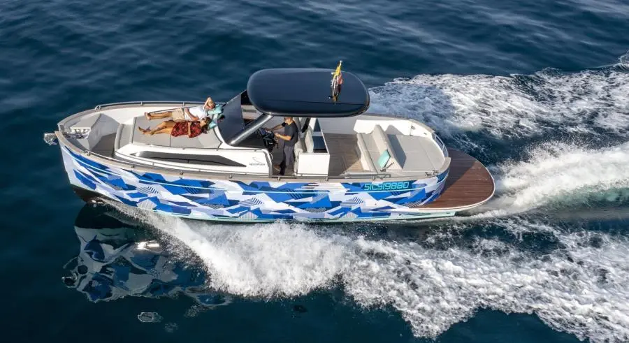 A gozzo boat cruising along the coast
